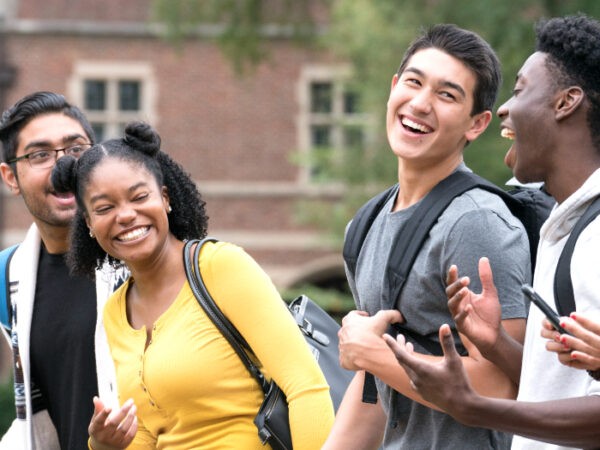 Diverse group of college students walking together and laughing